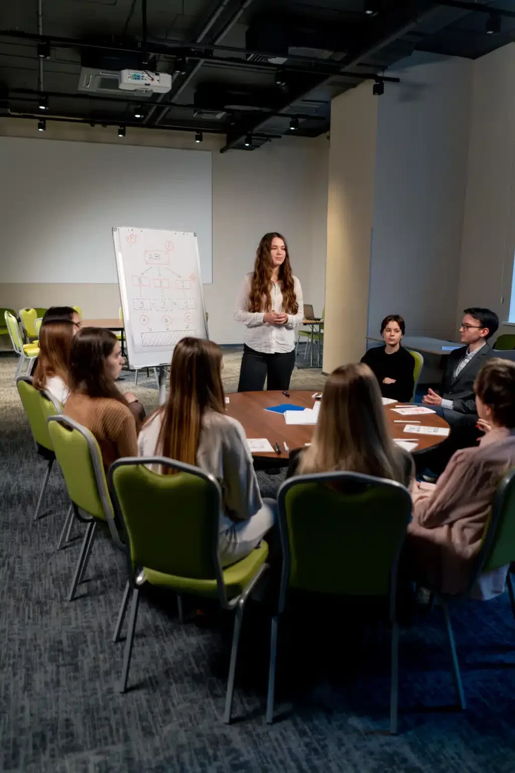 business conference or meeting at the hotel the girl on the flipchart shows the development plan for company